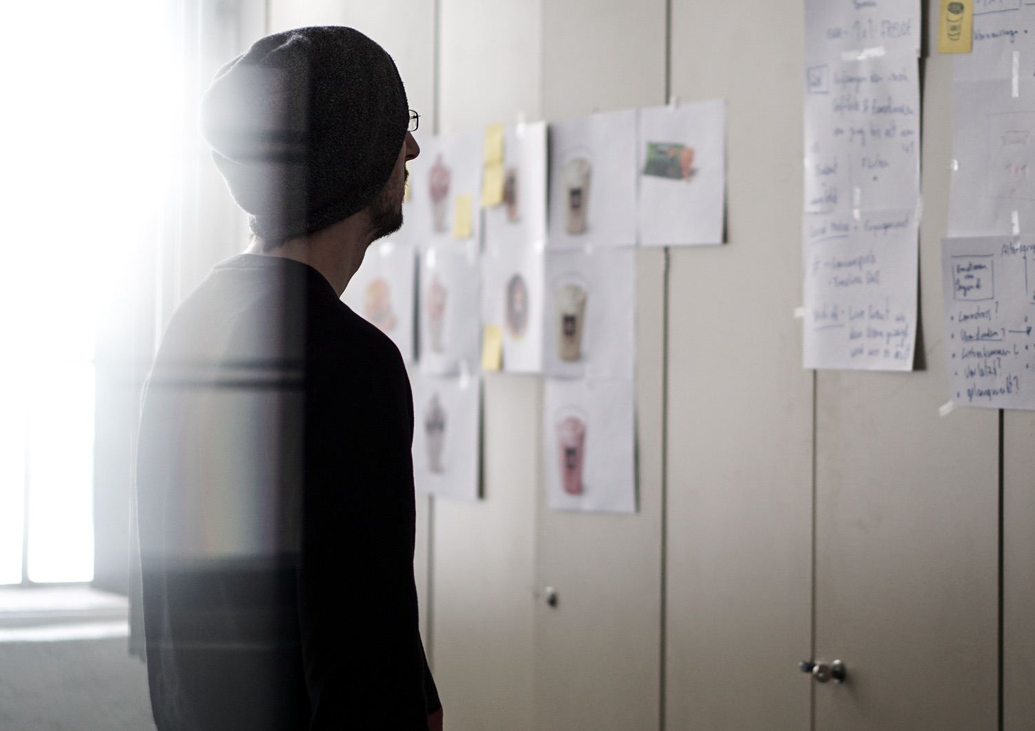 Man standing in front of a wall with post its